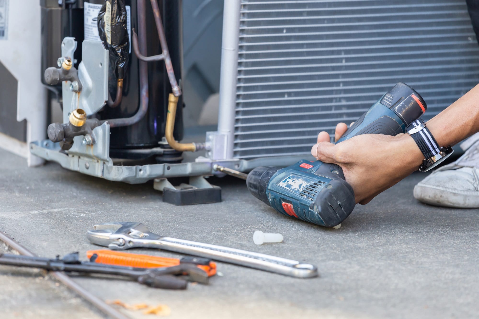 Technician working beside air-conditioning equipment